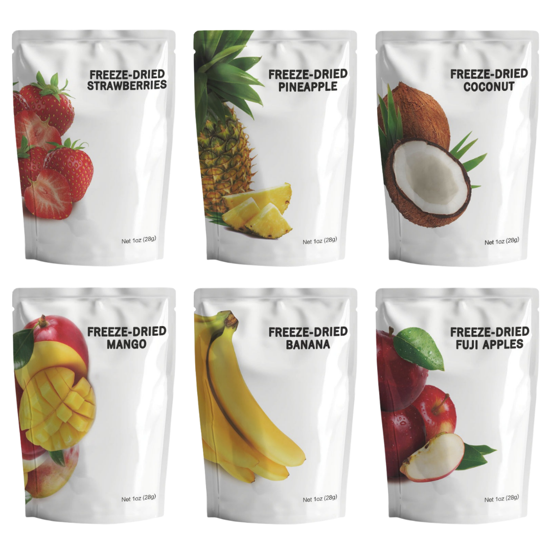 Assortment of freeze-dried fruit snack pouches including strawberries, pineapple, coconut, mango, bananas, and fuji apples.