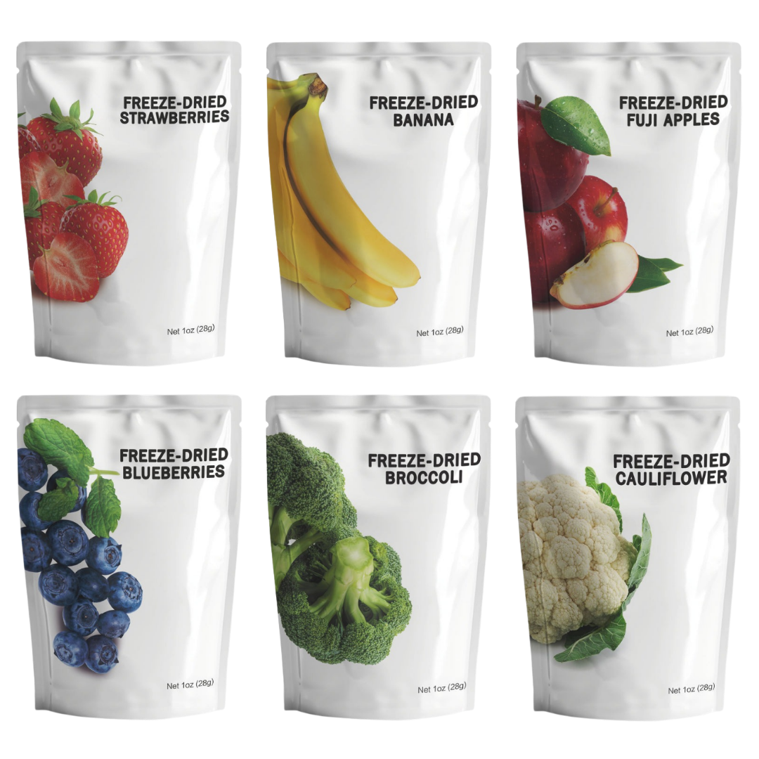 Assortment of freeze-dried fruit and vegetable pouches including strawberries, bananas, fuji apples, blueberries, broccoli, and cauliflower.