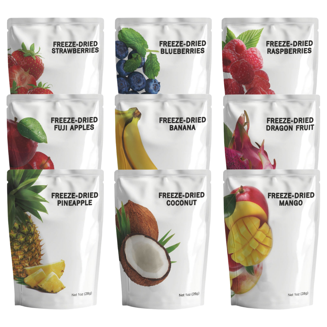 Assortment of freeze-dried fruit snack pouches including strawberries, blueberries, raspberries, Fuji apples, bananas, dragon fruit, pineapple, coconut, and mango. 