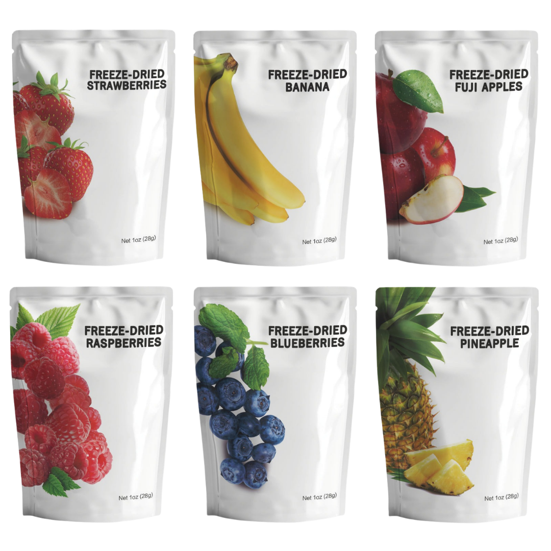 Assortment of freeze-dried fruit snack pouches including strawberries, bananas, fuji apples, raspberries, blueberries, and pineapple.